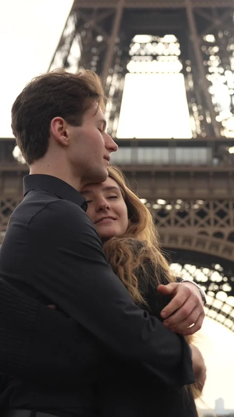 Loving couple embracing under Eiffel Tower in Paris Stock Footage 314040810