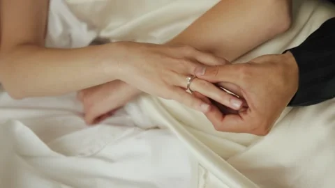 A loving couple exchanges wedding rings, symbolizing their deep and tender love Stock Footage 312879584