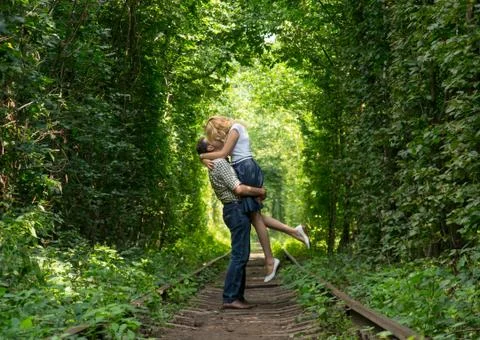 Loving couple in a green tunnel Stock Photos