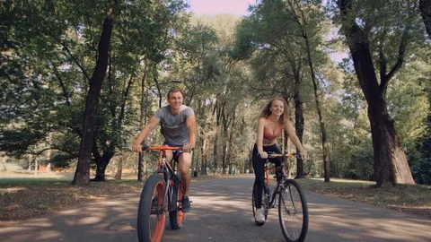 A loving couple is having fun riding bicycles Stock Footage 99609299