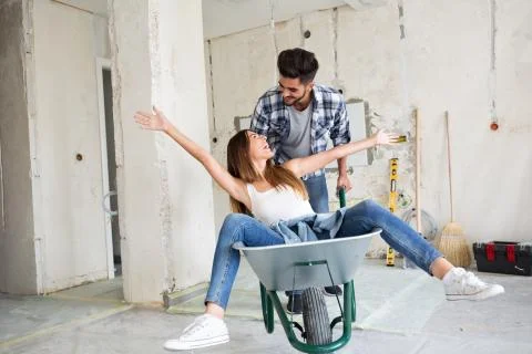 Loving couple is having fun while they are renovating house Stock Photos