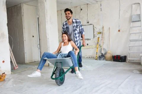 Loving couple is having fun while they are renovating house Stock Photos