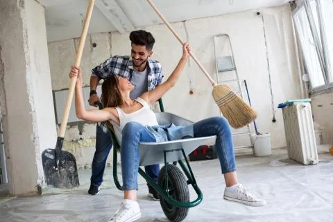 Loving couple is having fun while they are renovating house Stock Photos