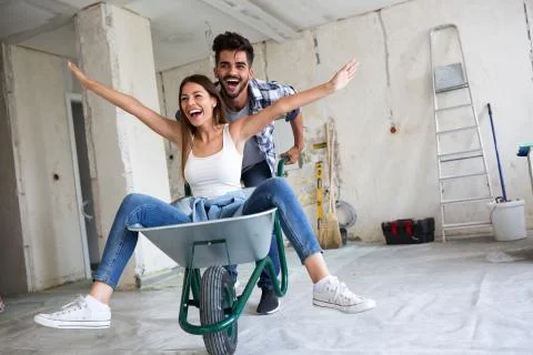 Loving couple is having fun while they are renovating house Stock Photos