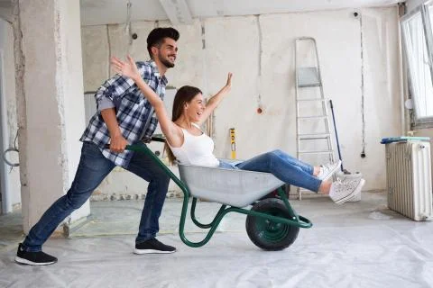 Loving couple is having fun while they are renovating house Stock Photos