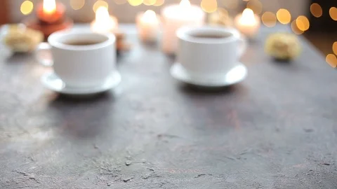 A loving couple hold hands at a romantic table with candles.  库存影片 108487162
