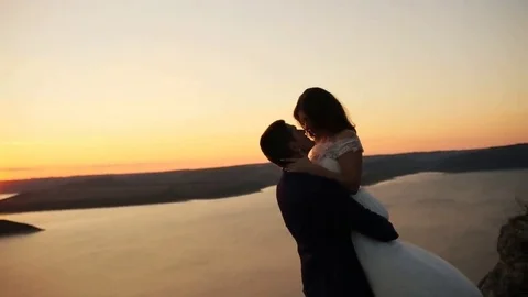Loving couple holding hands , while watching beautiful sunset Stock Footage 69151246