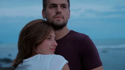 Loving couple hugging and looking into distance against the sky. Stock Footage 80266775