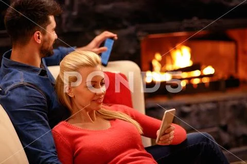 Loving couple in hugging and using mobile phone Stock Photos