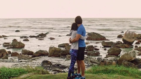 Loving couple hugging by seaside Stock Footage 76520630