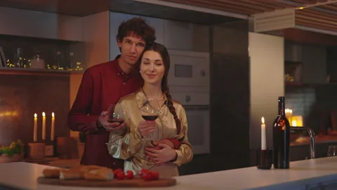 Loving couple looking at camera while embracing on kitchen Stock-Footage 171464157