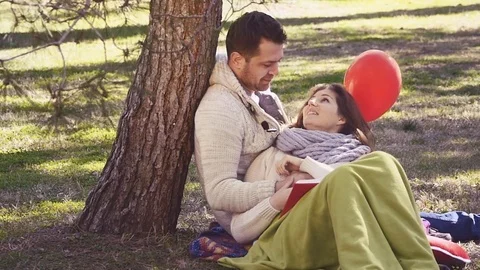 Loving couple reading a book Stock Footage 73097808