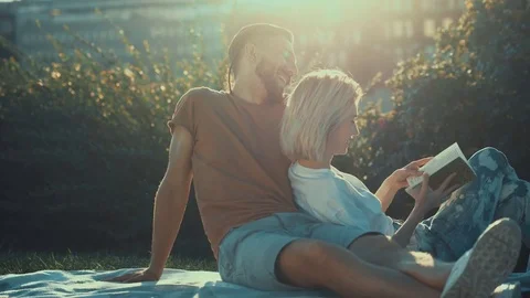 Loving couple reading a book Stock Footage 83360577