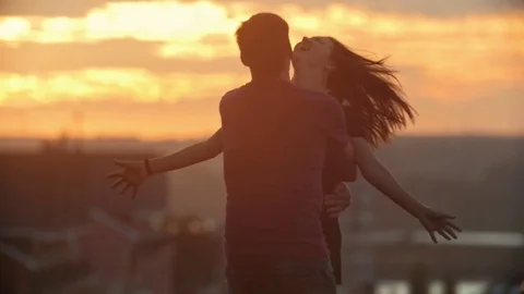 Loving Couple Romancing at sunset in slow motion Stock Footage 80128310