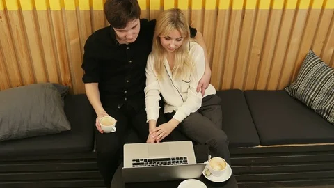 Loving couple sitting in drinking coffee enjoying time together Stock Footage 75713985