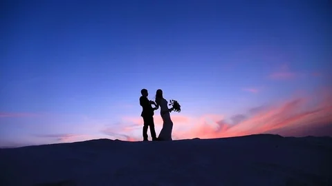 Loving couple at sunset Stock Footage 75357804