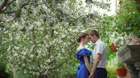 Loving Couple Talking in a Spring Blooming Park Stock Footage 130731705