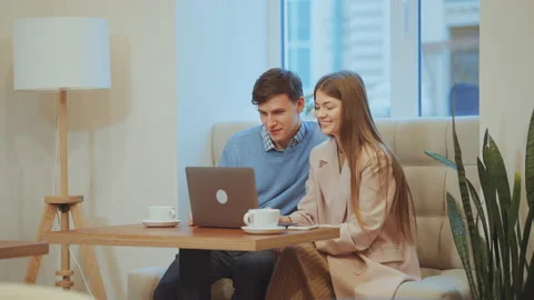 Loving couple using laptop in cafe Stock Footage 163807435