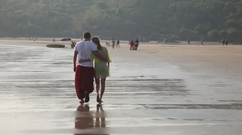 A loving couple walking on the beach Stock Footage 45594554