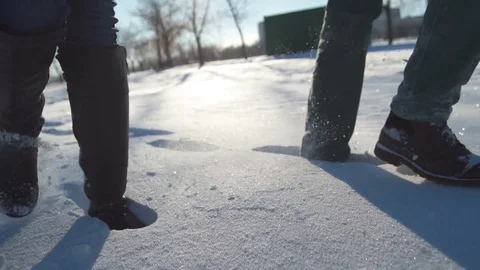 Loving couple walking in winter snow-covered park Stock Footage 80989623
