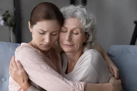Loving daughter hug and comfort old upset mom Stock Photos