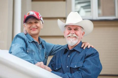 Loving elderly couple posing on camera. Pensioners hug each other. Happy old  Stock Photos