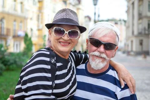 Loving elderly couple posing on camera. Stock Photos
