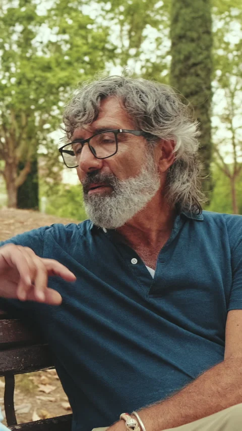 Loving elderly couple talking while sitting in the park Stock Footage 255505502