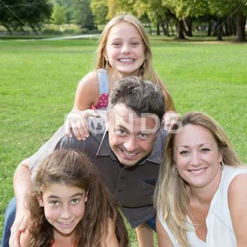 Loving family of four, mother, father and two girls Stock Photos