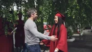 Loving Father Is Congratulating His Daughter On Graduation Day, People Are Stock Footage