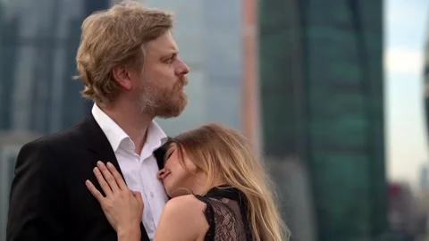 A loving harmonious couple: a bearded man in a jacket and shirt and a young 動画素材 134736666