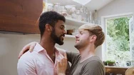 Loving Male Gay Couple Hugging And Kissing At Home In Kitchen Stock Footage