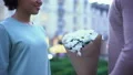 Loving man presenting flowers to pretty girlfriend, hugging on summer date city 4k or 4k+ Resolution