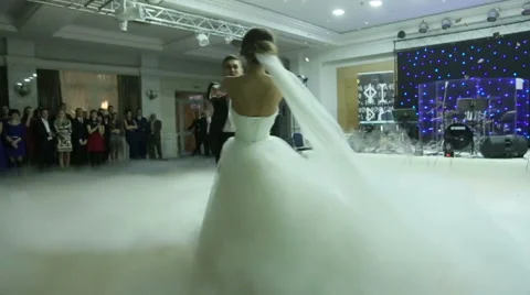 Loving newlywed couple dancing the first dance at wedding shrouded by white Stock Footage 62442860