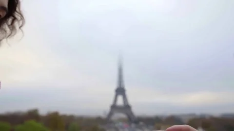Loving pair is approaching to each other against Eiffel tower looking to faces Vídeo Stock 98811351