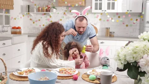 Loving parents playing with Easter bunnies Stock Footage 234740636
