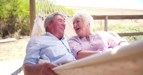 Loving retired senior couple laughing together Stock Footage