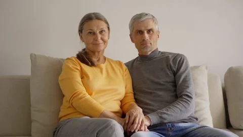 Loving senior couple posing on sofa Stock Footage 133525454