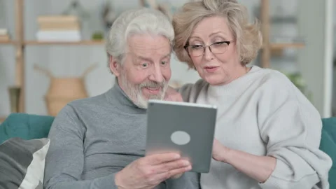 Loving Senior Old Couple using Tablet Together at Home Stock Footage 148202738