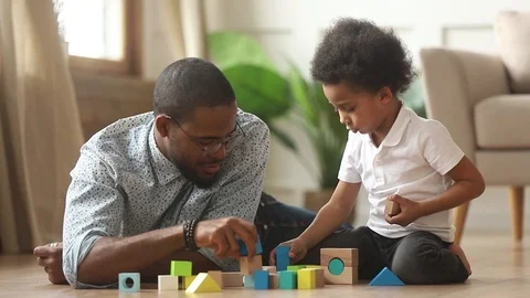 Loving single black father helping little kid son playing together Stock Footage