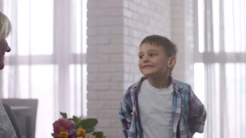 Loving son presenting gift box to surprised mother Stock Footage 104010234