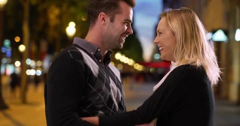 Loving young couple having fun on the Champs-Elysees at night Stock Footage 85333310