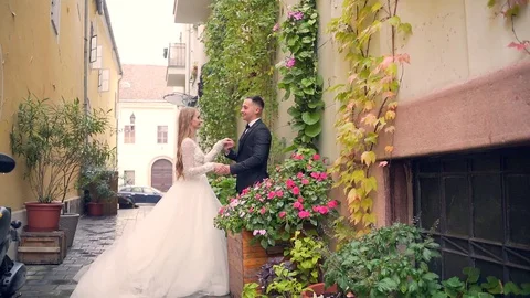 Loving young wedding couple, bride in white dress, groom in black suit. walking  Stock Footage 129508893