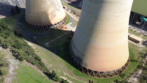 Low Aerial Between Massive Cooling Tower Bases Stock Footage 334894640