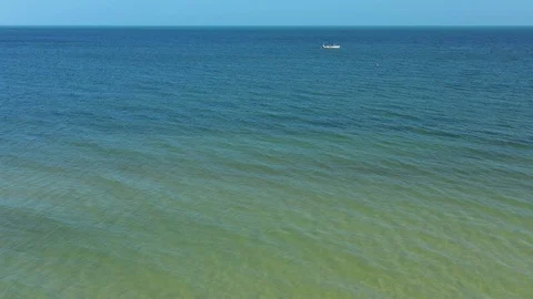 Low aerial camera rushing towards lone fishing boat. Stock Footage 104689290