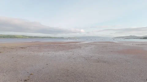 Low Aerial Dolly Over Sandy Bay at Dawn with Anchored Boats Video stock 337310318