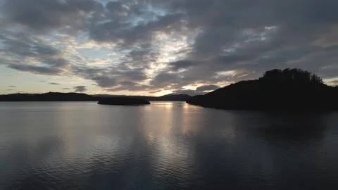 Low Aerial Drone shot of Loch Lomond. Silhouette. Sunset. Scotland. Stock Footage