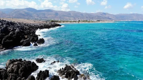 Low aerial fly along rocky beach and blue sea, Crete Stock Footage 101070156
