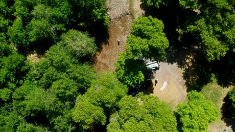 Low Aerial looking down at river with kids playing in summer at mountain park 4K 스톡 동영상 122535384