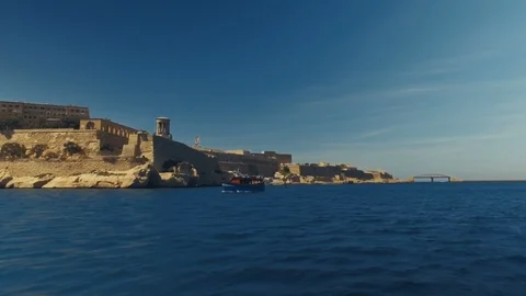 Low Aerial orbiting shot around a traditional Boat entering in Malta Stock Footage 91108305